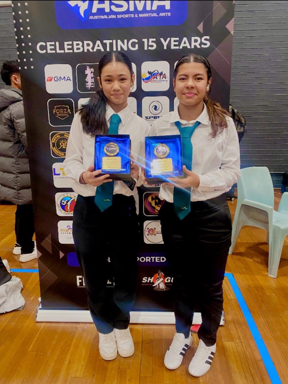 Gurkhas Taekwondo students holding achievement awards