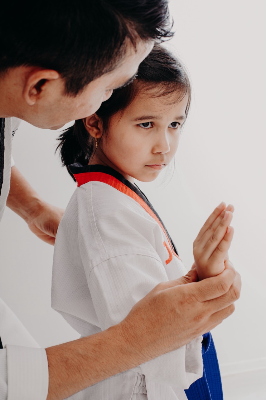 Jiwan Joshi guiding a young taekwondo student